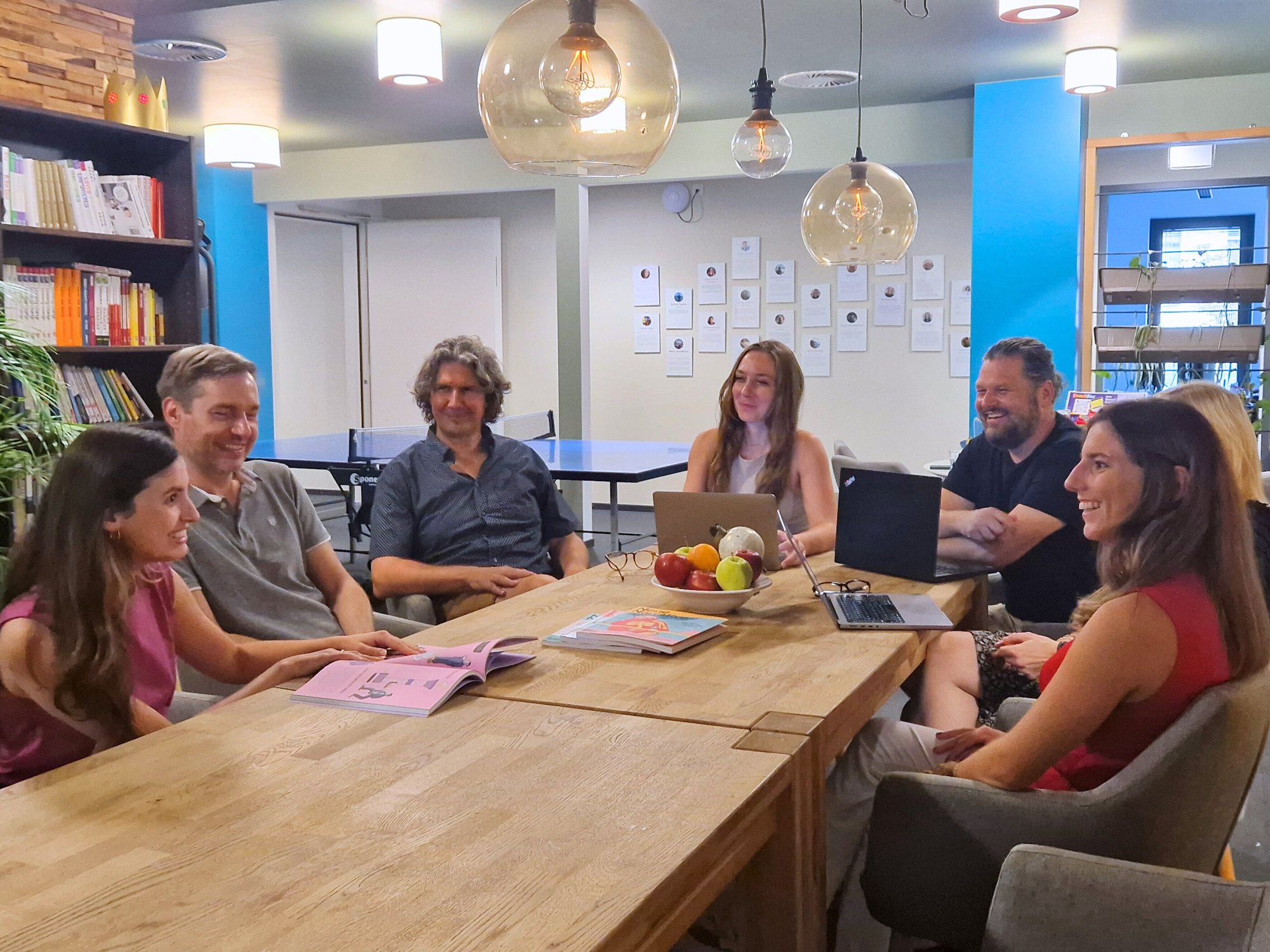 Milengo team having a meeting around a table